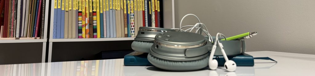 Writing book and headphones